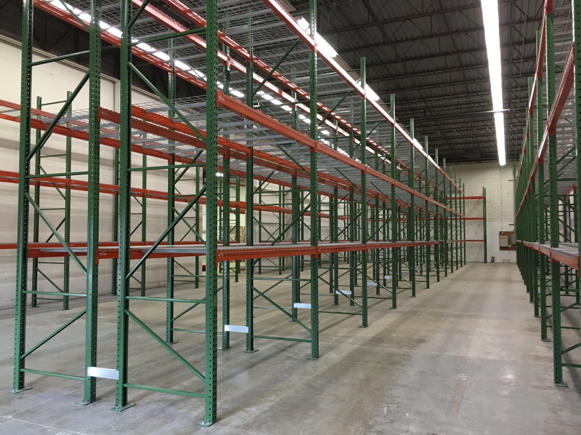 Long rows of green and orange selective pallet rack