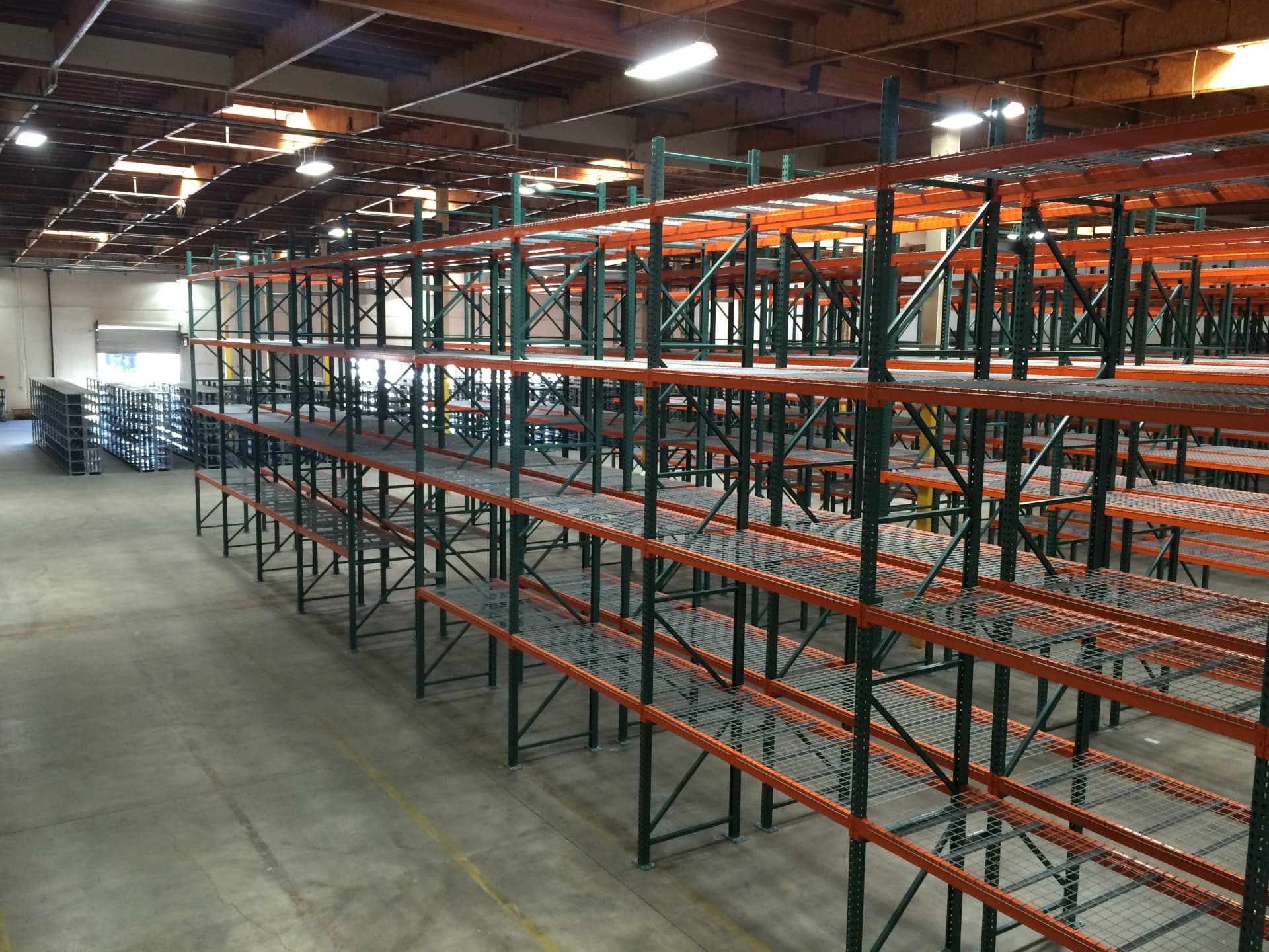 Wide view of a warehouse racking layout with wire decking
